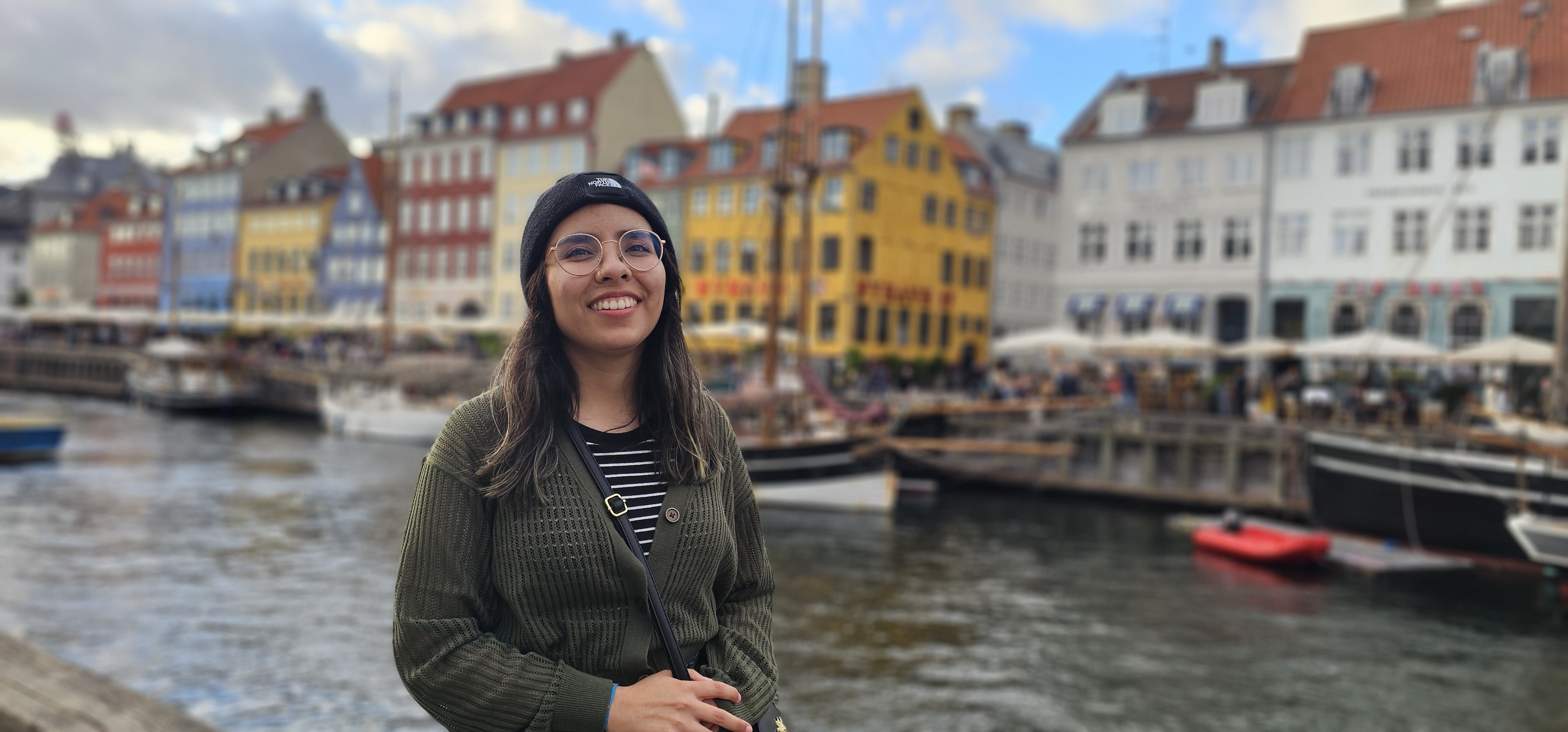 Picture of Sofi at the Copenhagen canal where all the pretty and colorful houses are.