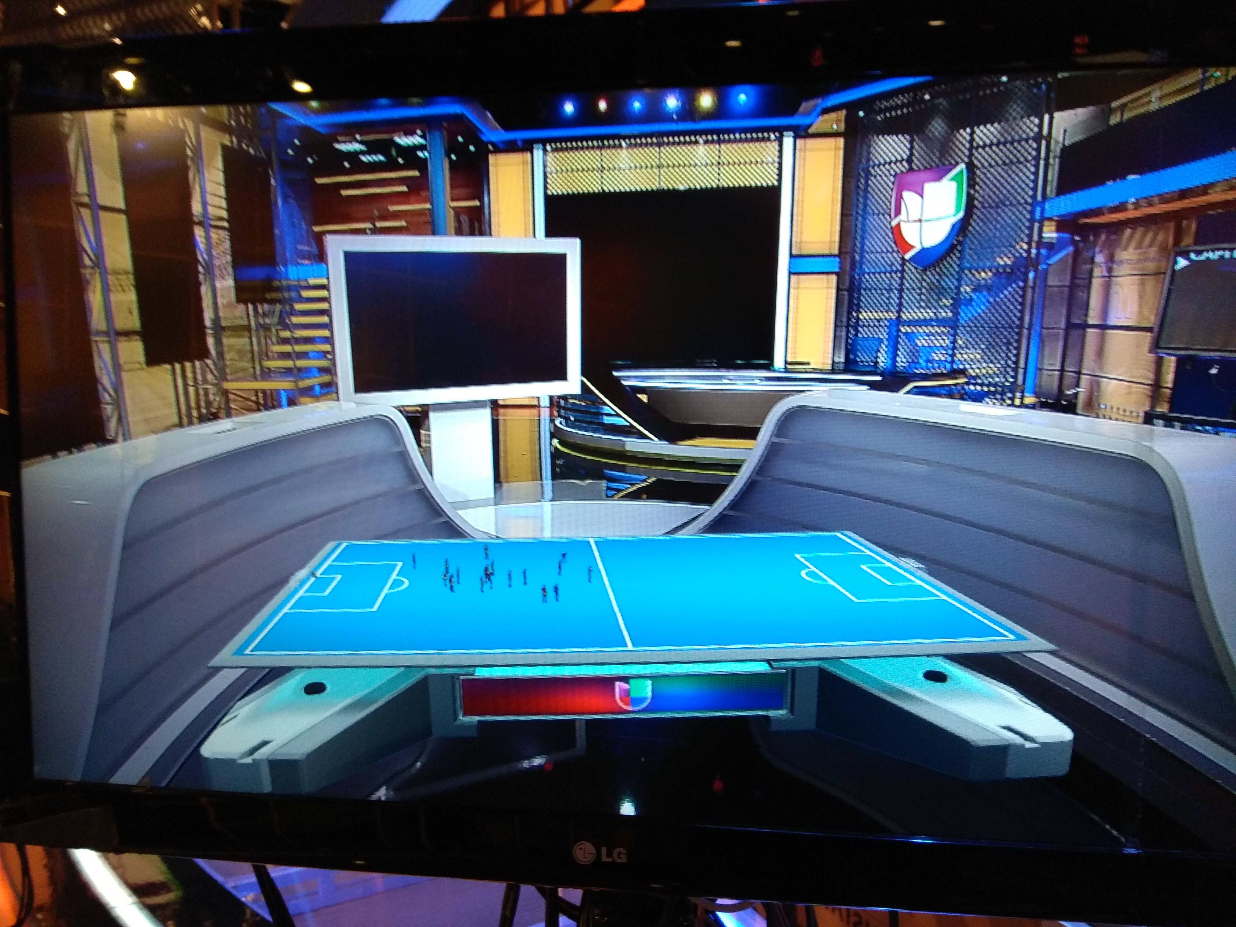 Picture of a studio camera showing a virtual soccer field inside a Sports Television Studio